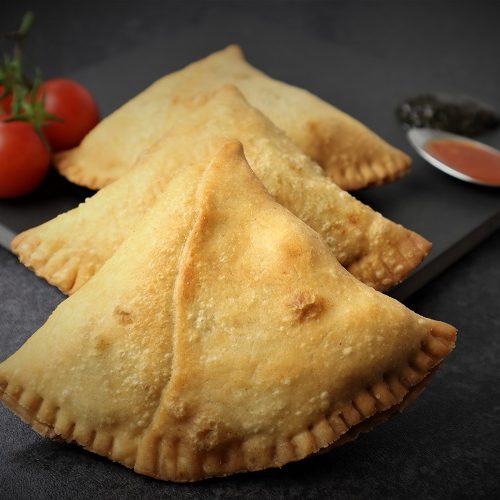 3 Samosa being served with tomato ketchup