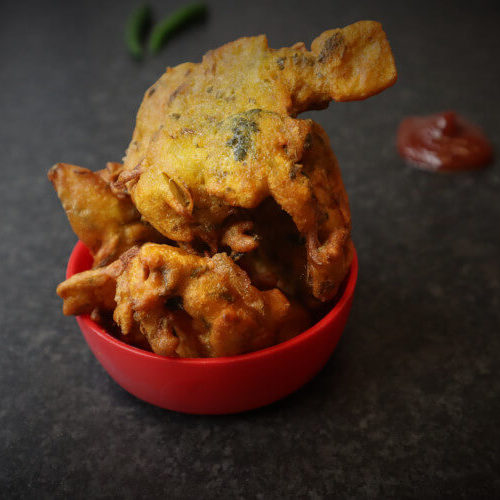Pakora on a bowl served with tomato ketchup
