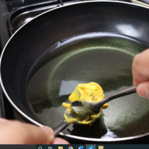 pakora being fried in hot oil