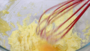 adding an egg and whisk